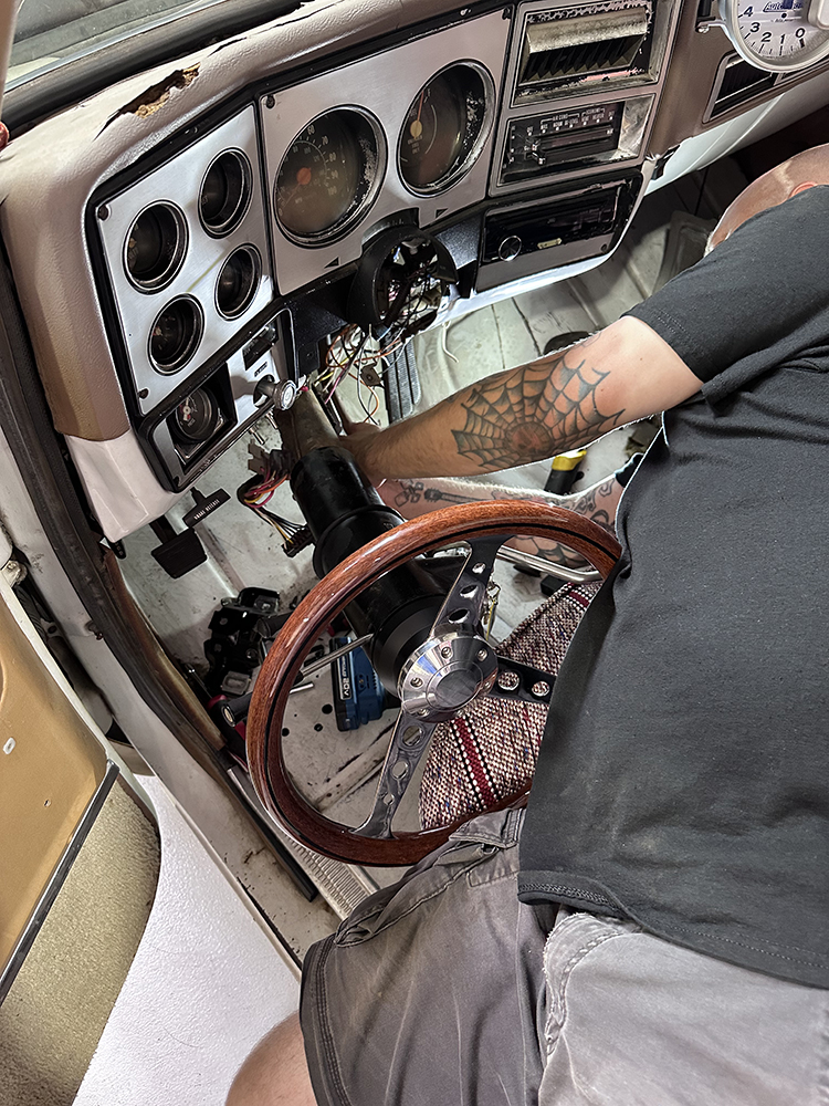 19 Technician removing the old steering column from the classic Chevy truck’s interior