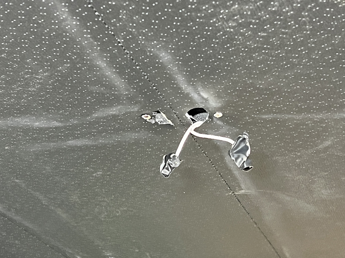 19 Wiring exposed through a hole for dome light installation in a 1970 Chevy Nova headliner
