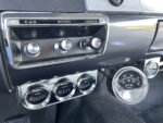 20 1957 Ford Custom dashboard featuring auxiliary Sunpro gauges and a vintage push button lighter