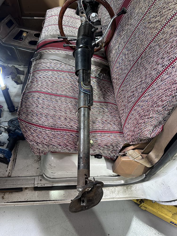 20 Original steering column placed on the bench seat after removal