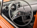 21 1957 Chevrolet Bel Air featuring a classic chrome rimmed steering wheel with Corvette emblem and a retro modern dash