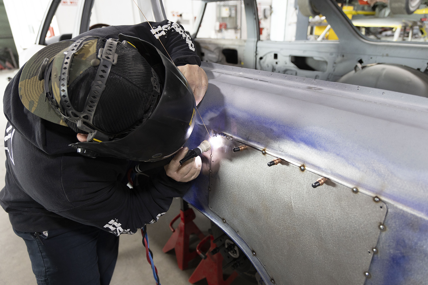 21 TIG welder precisely fuses the patch panel to the quarter panel for a seamless repair on the 1966 Chevelle wagon