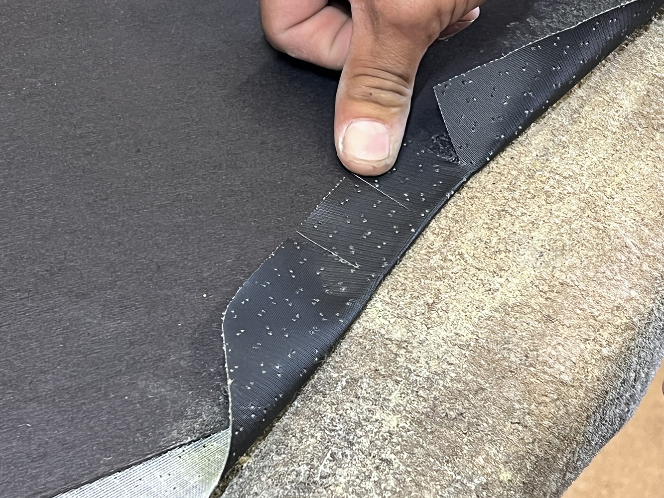 21 Wrapping and securing the edge of the headliner fabric for a clean finish in a 1970 Chevy Nova