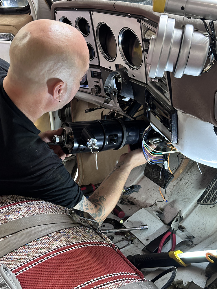 23 Aligning and mounting the new steering column inside the truck’s dash
