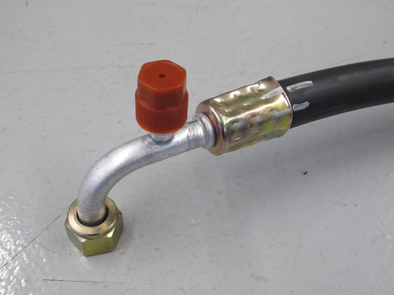 23 Completed beadlock fitting on an AC hose with a protective cap on the service port