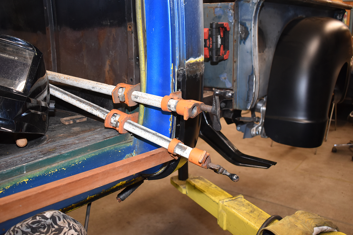 23 Large clamps securing a rocker panel replacement for precise welding alignment