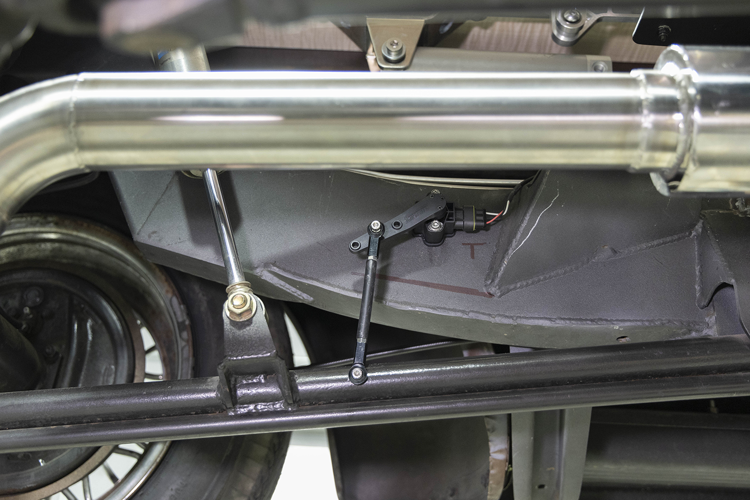 23 Rear ride height sensor mounted near the exhaust