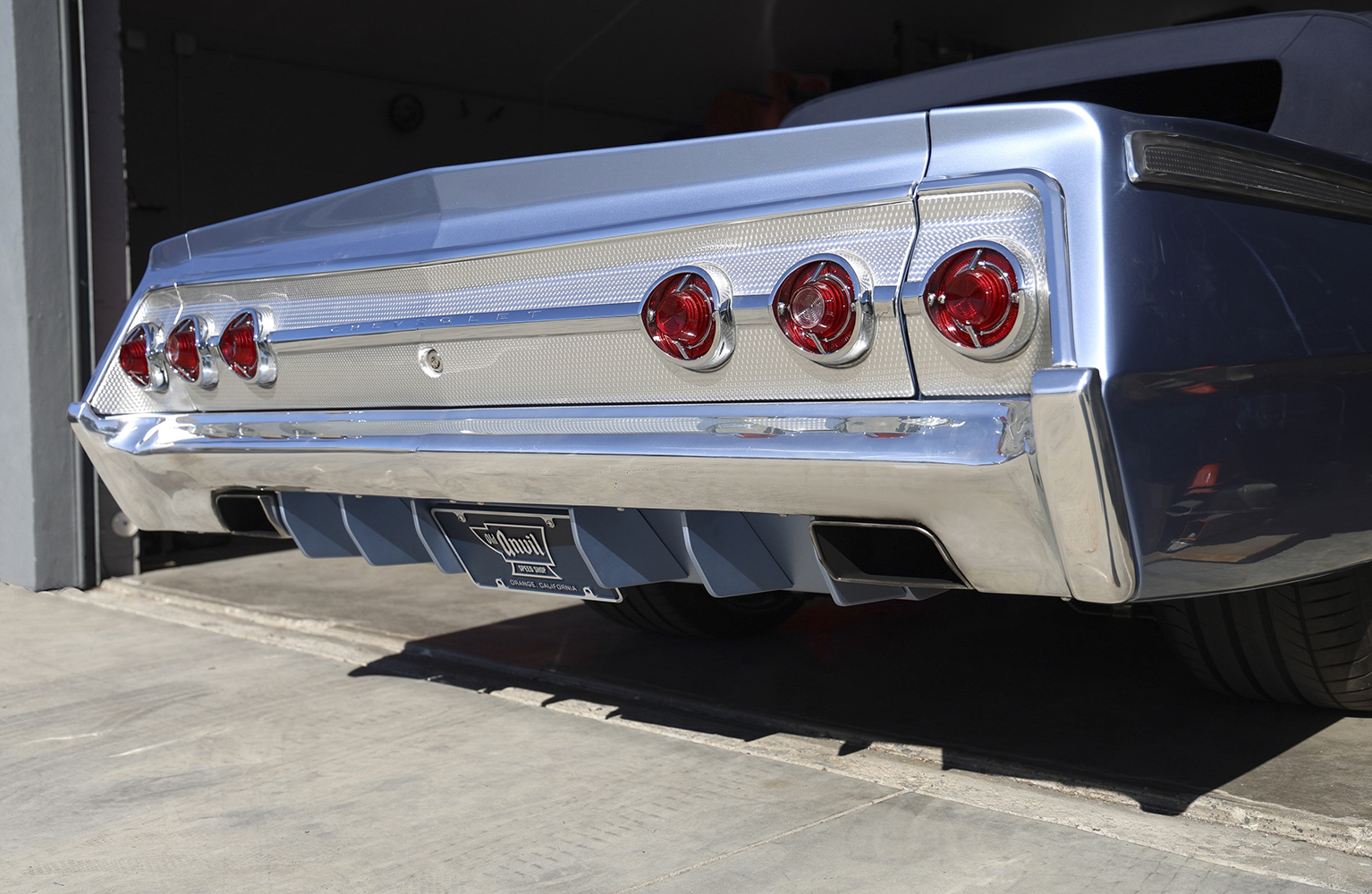 23 The completed rear end of a 1962 Chevy Impala featuring a custom aluminum diffuser and polished bumper