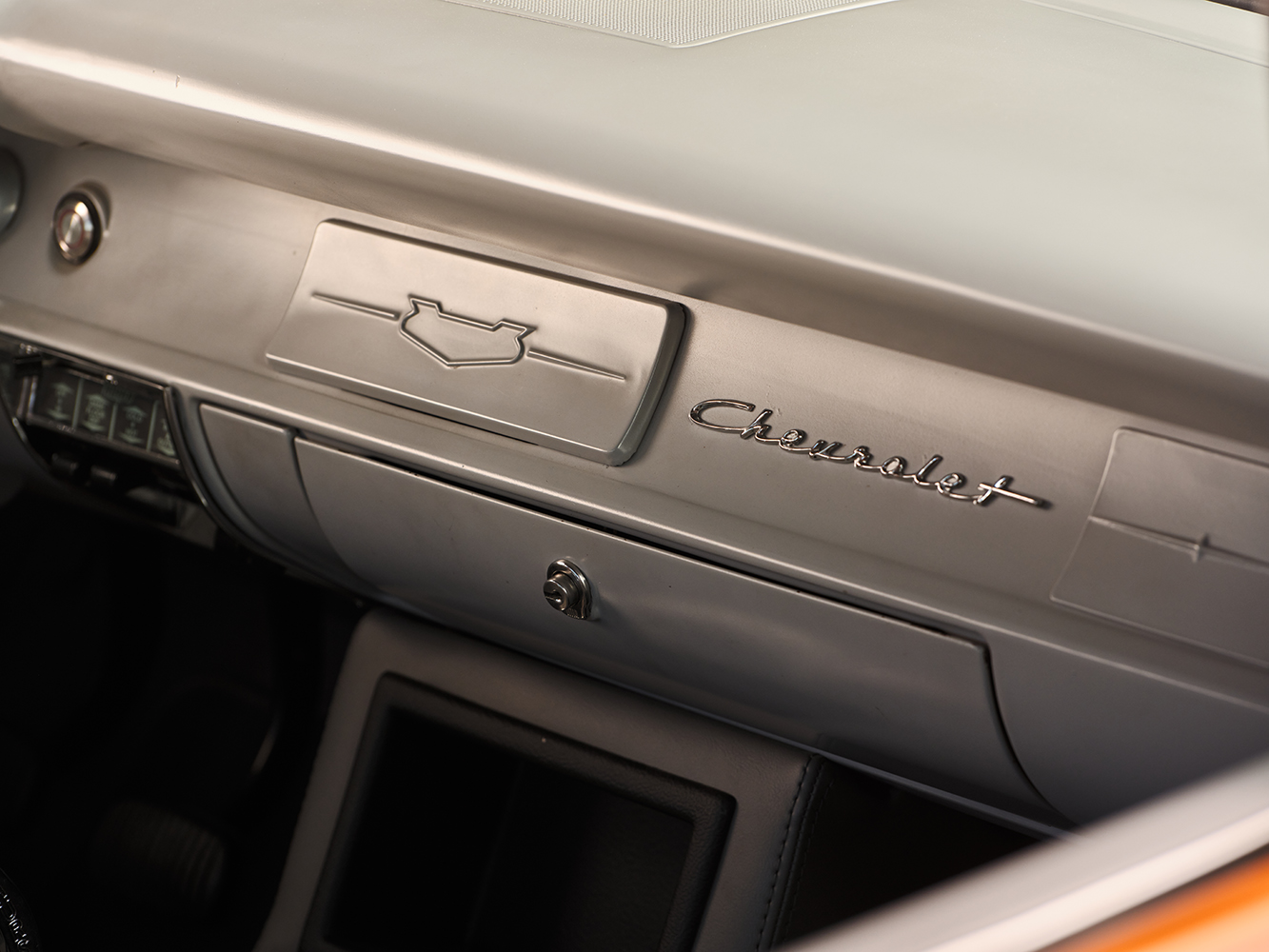 24 1957 Chevrolet Bel Air dashboard with classic Chevrolet script glove compartment and a sleek brushed metal finish