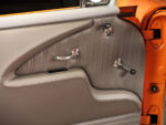 28 1957 Chevrolet Bel Air door panel with custom stitched leather polished handles and a retro modern aesthetic
