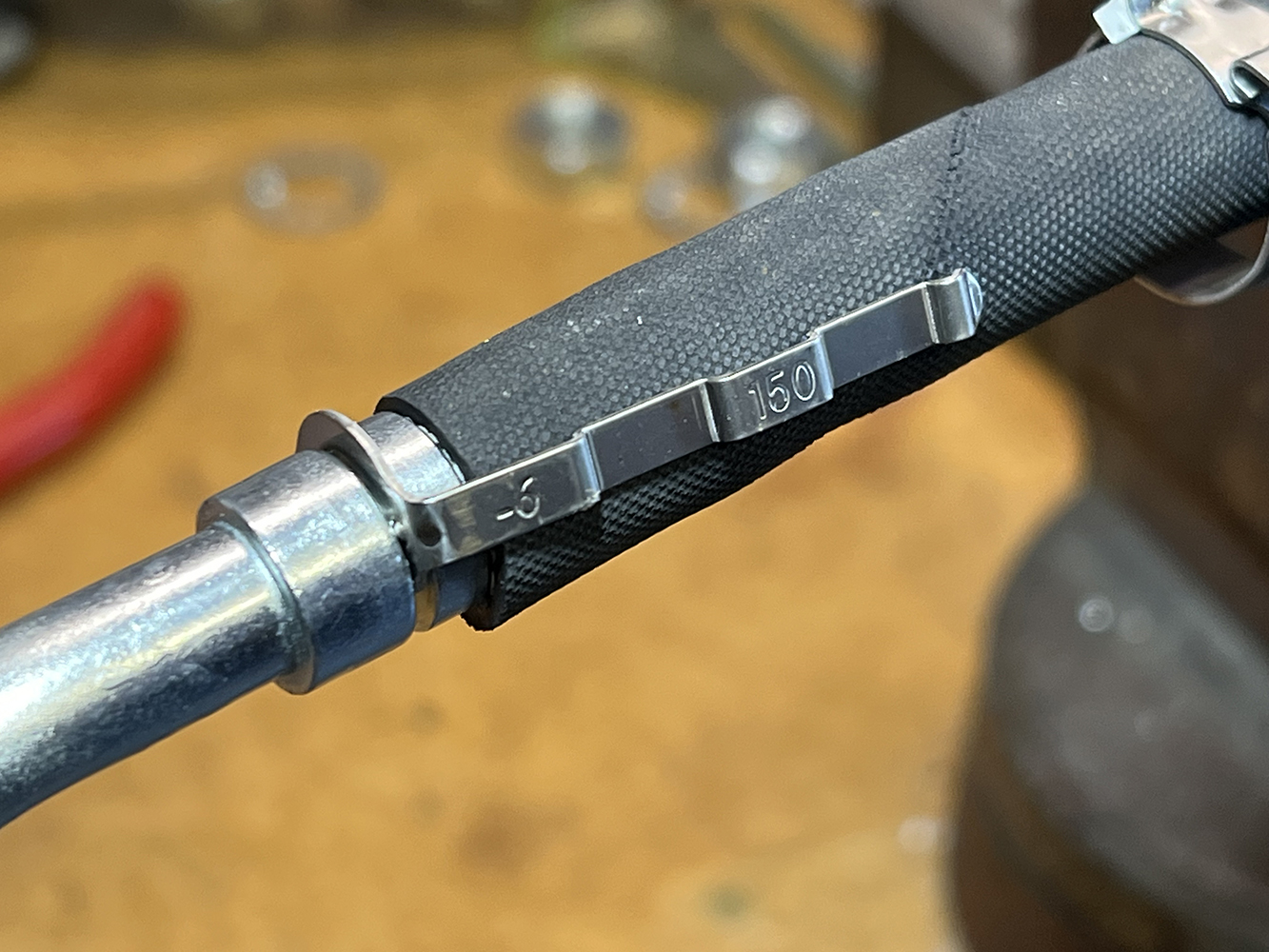 28 Hose with a stainless steel band clamp labeled 6 150 for a secure connection