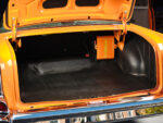 29 1957 Chevrolet Bel Air trunk space featuring a pinstriped battery box and factory style rubber mat