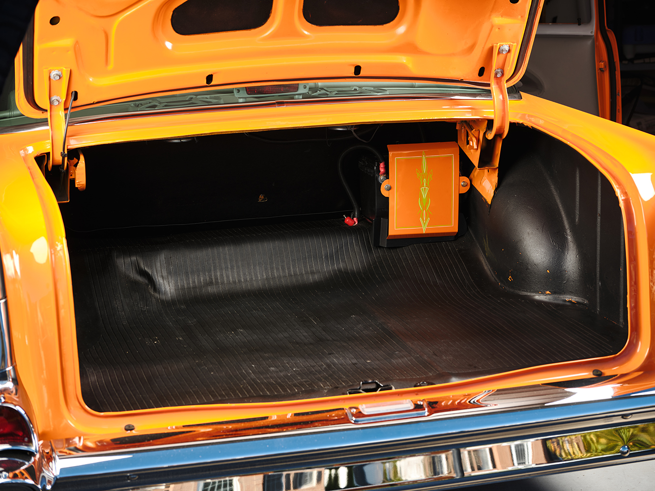 29 1957 Chevrolet Bel Air trunk space featuring a pinstriped battery box and factory style rubber mat