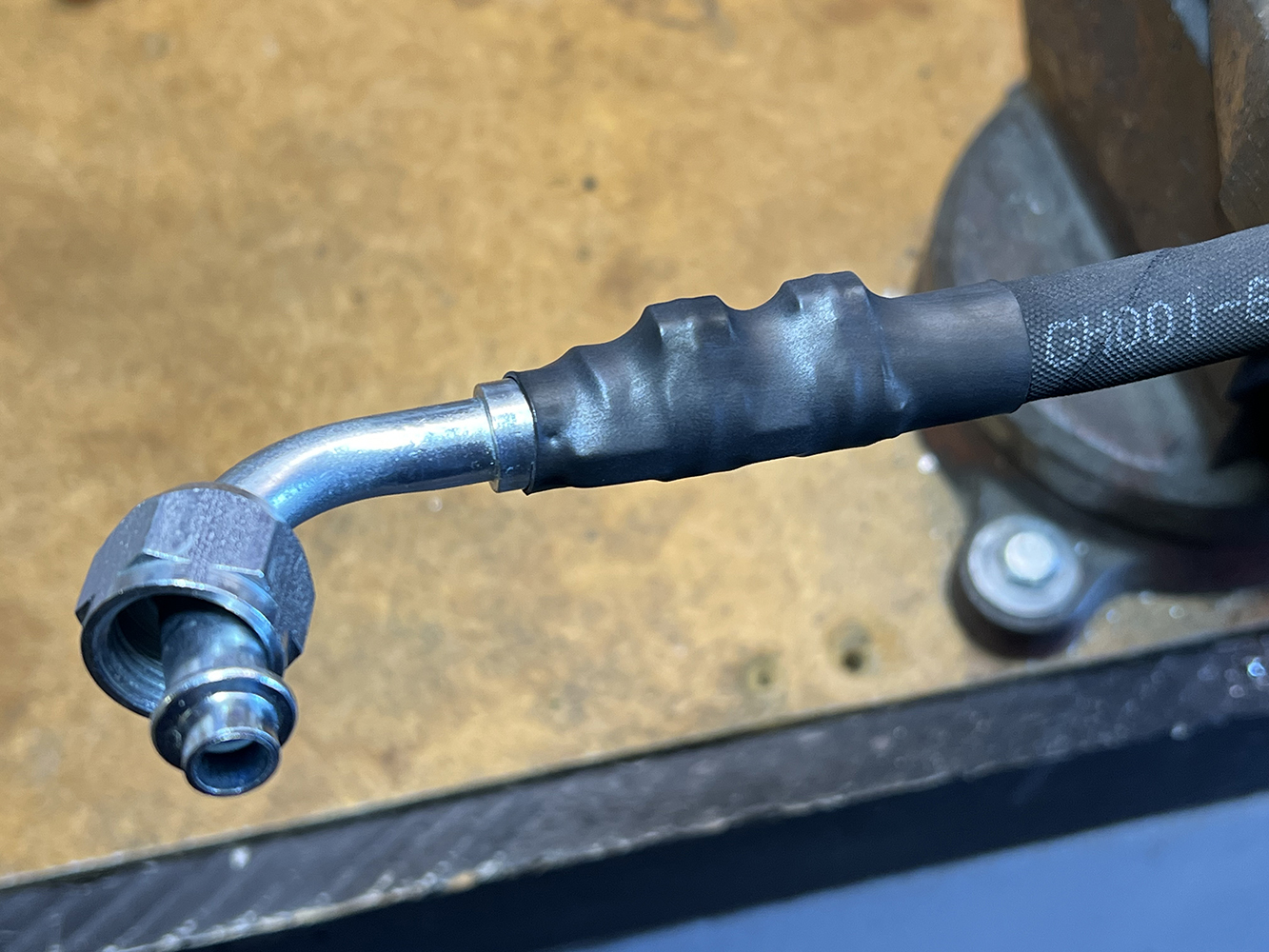 32 crimped AC hose with a heat shrink cover over the fitting for additional protection