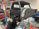00 Classic truck cab undergoing rocker panel replacement in a restoration shop