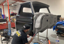 00 Classic truck cab undergoing rocker panel replacement in a restoration shop