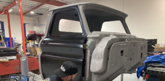 00 Classic truck cab undergoing rocker panel replacement in a restoration shop