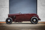 01 1932 Ford Roadster in deep burgundy featuring a minimalist highboy stance with black steel wheels and chrome hubcaps