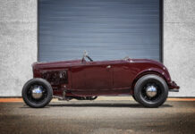01 1932 Ford Roadster in deep burgundy featuring a minimalist highboy stance with black steel wheels and chrome hubcaps