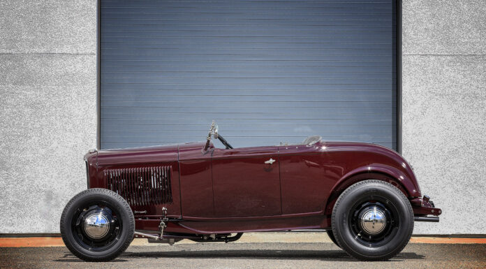 01 1932 Ford Roadster in deep burgundy featuring a minimalist highboy stance with black steel wheels and chrome hubcaps
