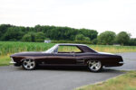 01 1963 Buick Riviera custom lowrider on polished five spoke wheels with deep metallic paint and chrome trim