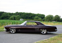01 1963 Buick Riviera custom lowrider on polished five spoke wheels with deep metallic paint and chrome trim