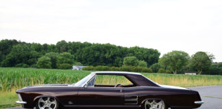01 1963 Buick Riviera custom lowrider on polished five spoke wheels with deep metallic paint and chrome trim