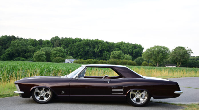 01 1963 Buick Riviera custom lowrider on polished five spoke wheels with deep metallic paint and chrome trim