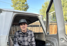 01 young builder sitting inside the cab of the 1964 Chevy truck project