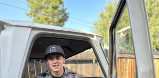 01 young builder sitting inside the cab of the 1964 Chevy truck project