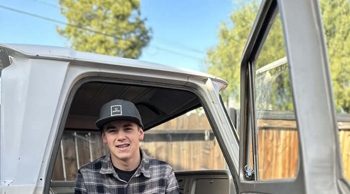 01 young builder sitting inside the cab of the 1964 Chevy truck project