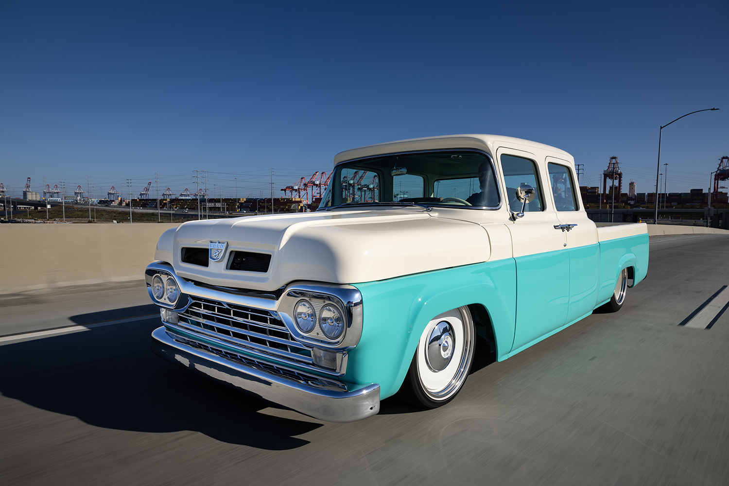 03 1960 Ford F 100 rolling down the highway with a classic stance and chrome grille