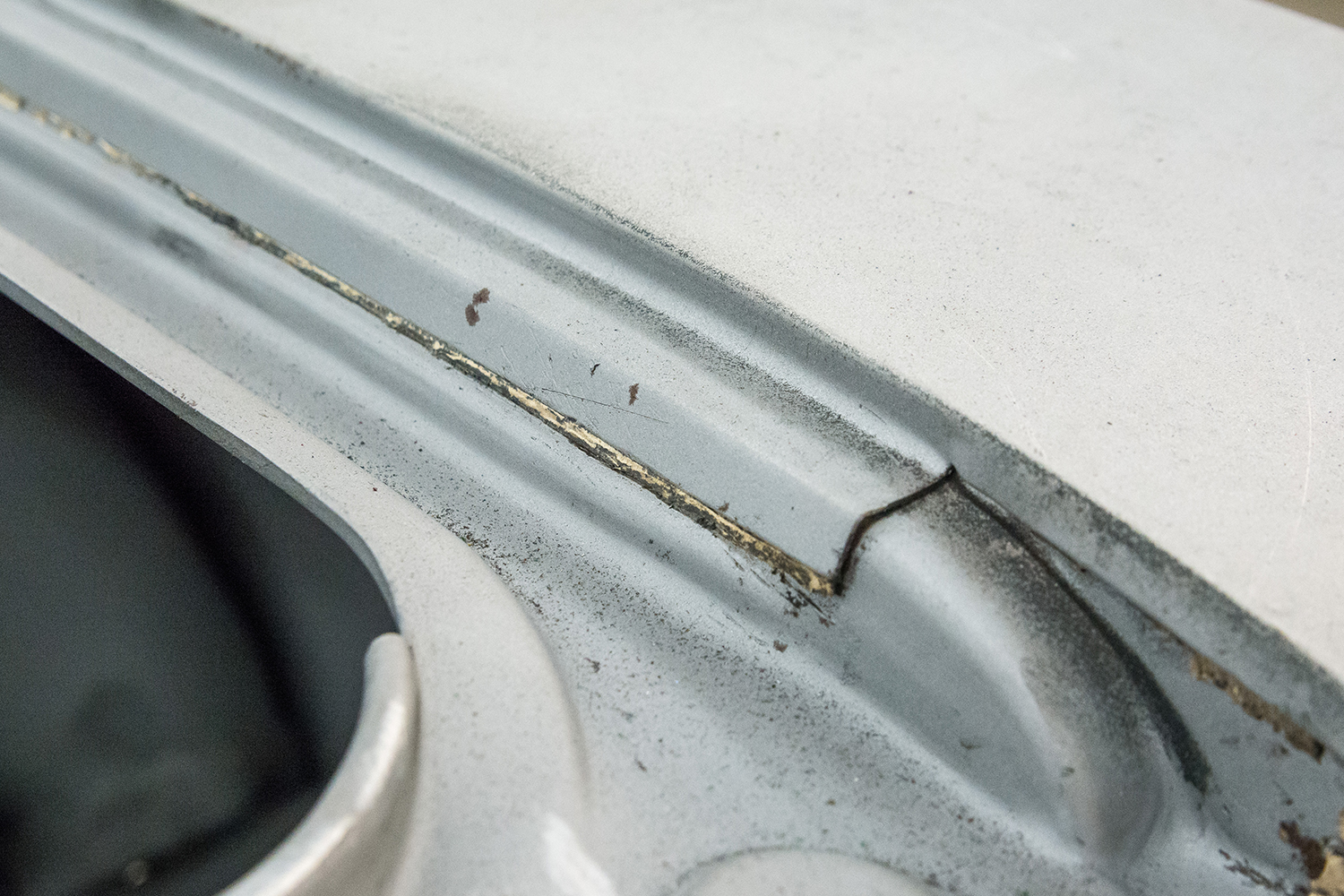 03 cracked and deteriorated factory seam on the car’s body revealing corrosion and previous wear