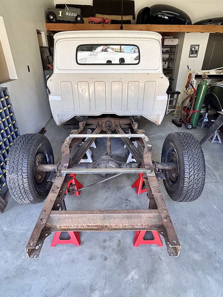 03 frame stripped down and supported on jack stands for restoration