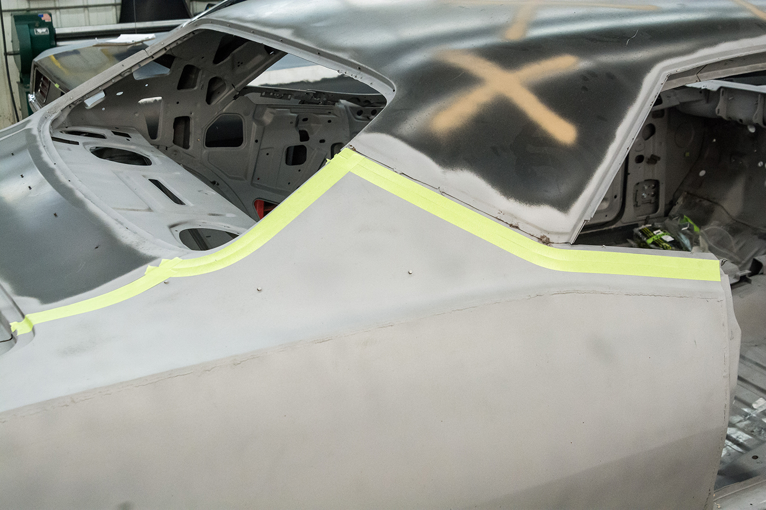 04 Masking tape outlining the cut area for precise removal of the damaged quarter panel