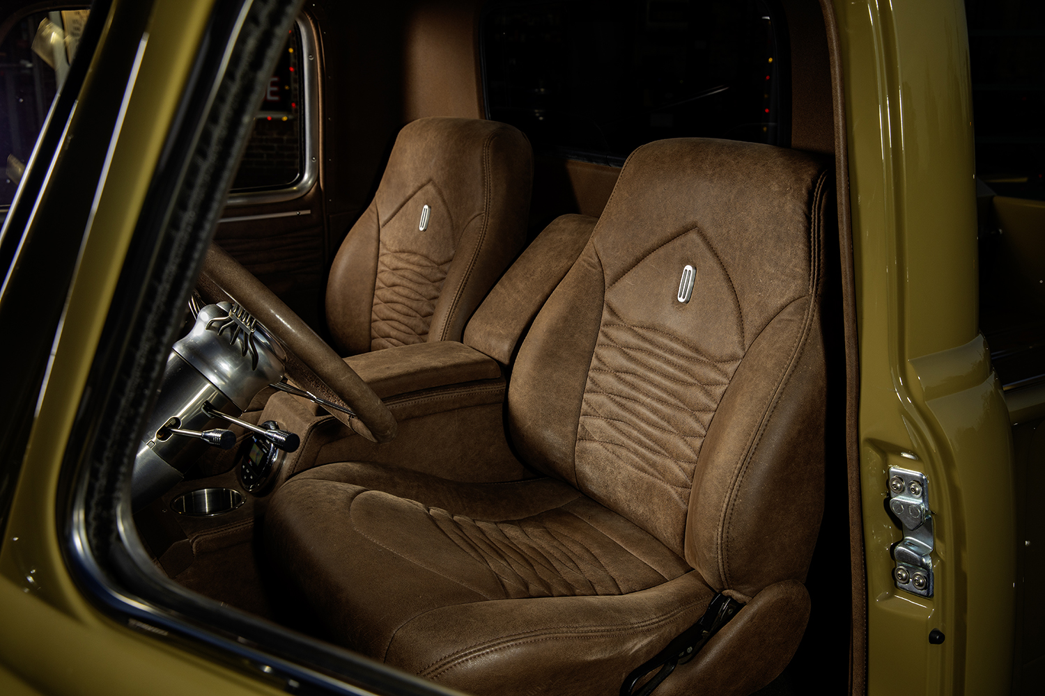 05 1952 Chevrolet 3100 interior with custom brown leather bucket seats and stitched detailing