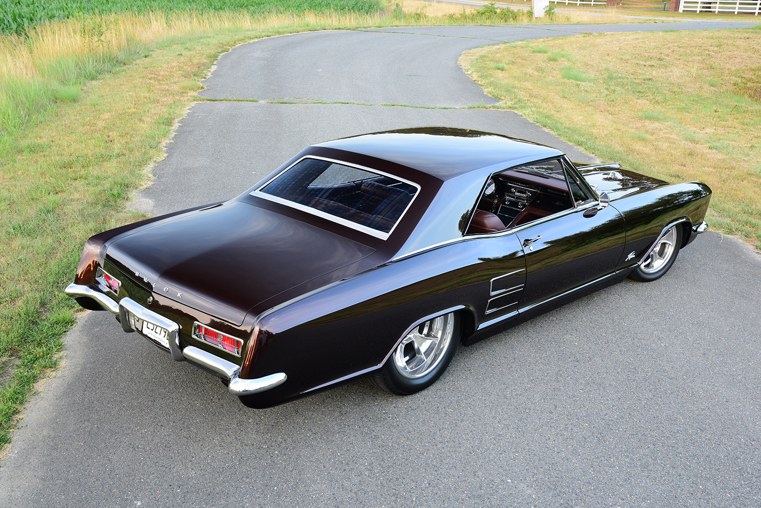 05 1963 Buick Riviera rolling shot with black paint custom interior and lowered stance