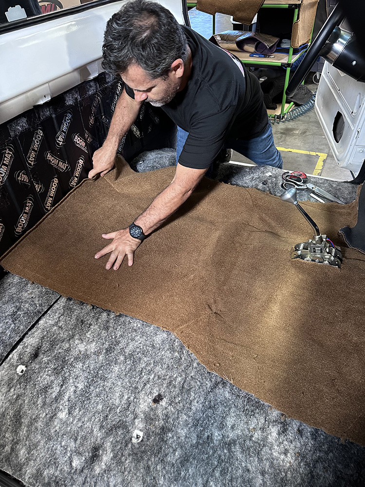 05 Professional installing brown carpet along C10’s rear cab wall