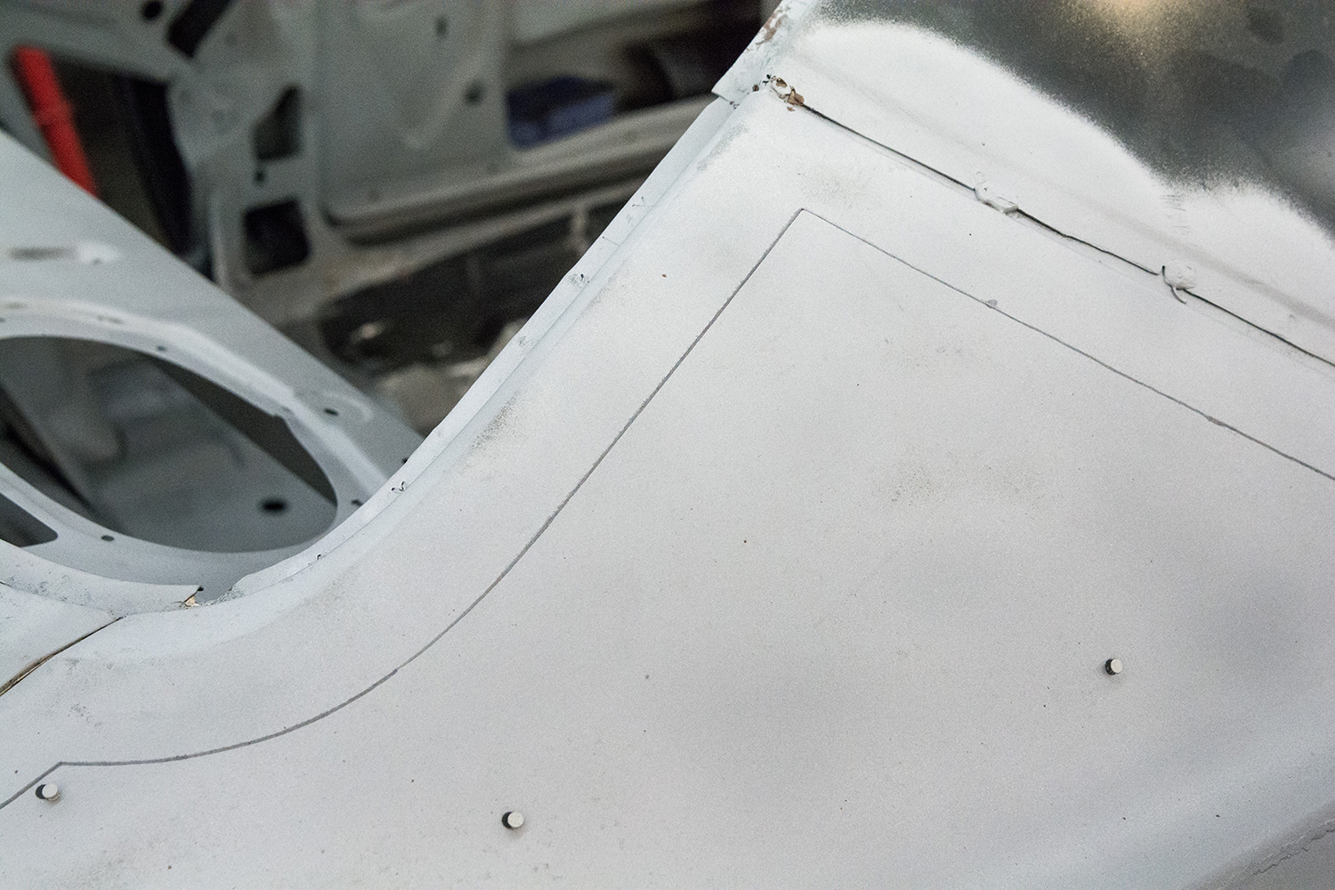 05 marked and outlined cut section on the quarter panel preparing for precise removal