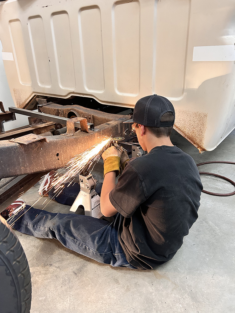06 Grinding metal on the frame creating sparks during modification