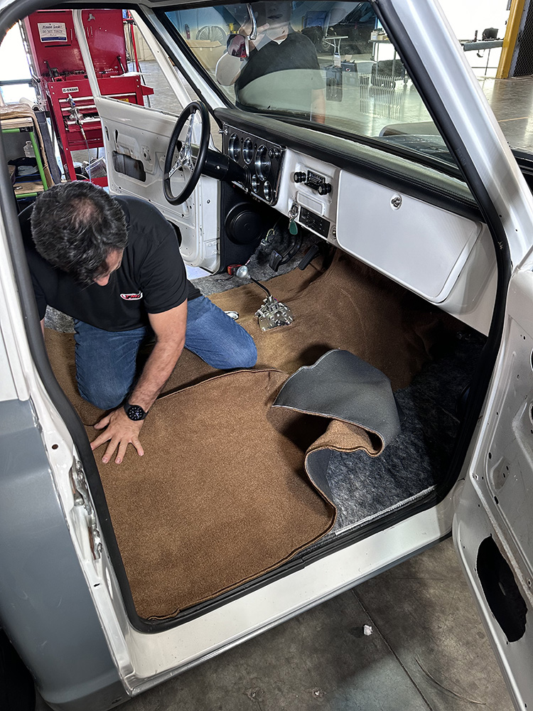 06 Technician carefully fitting carpet around contours and insulation