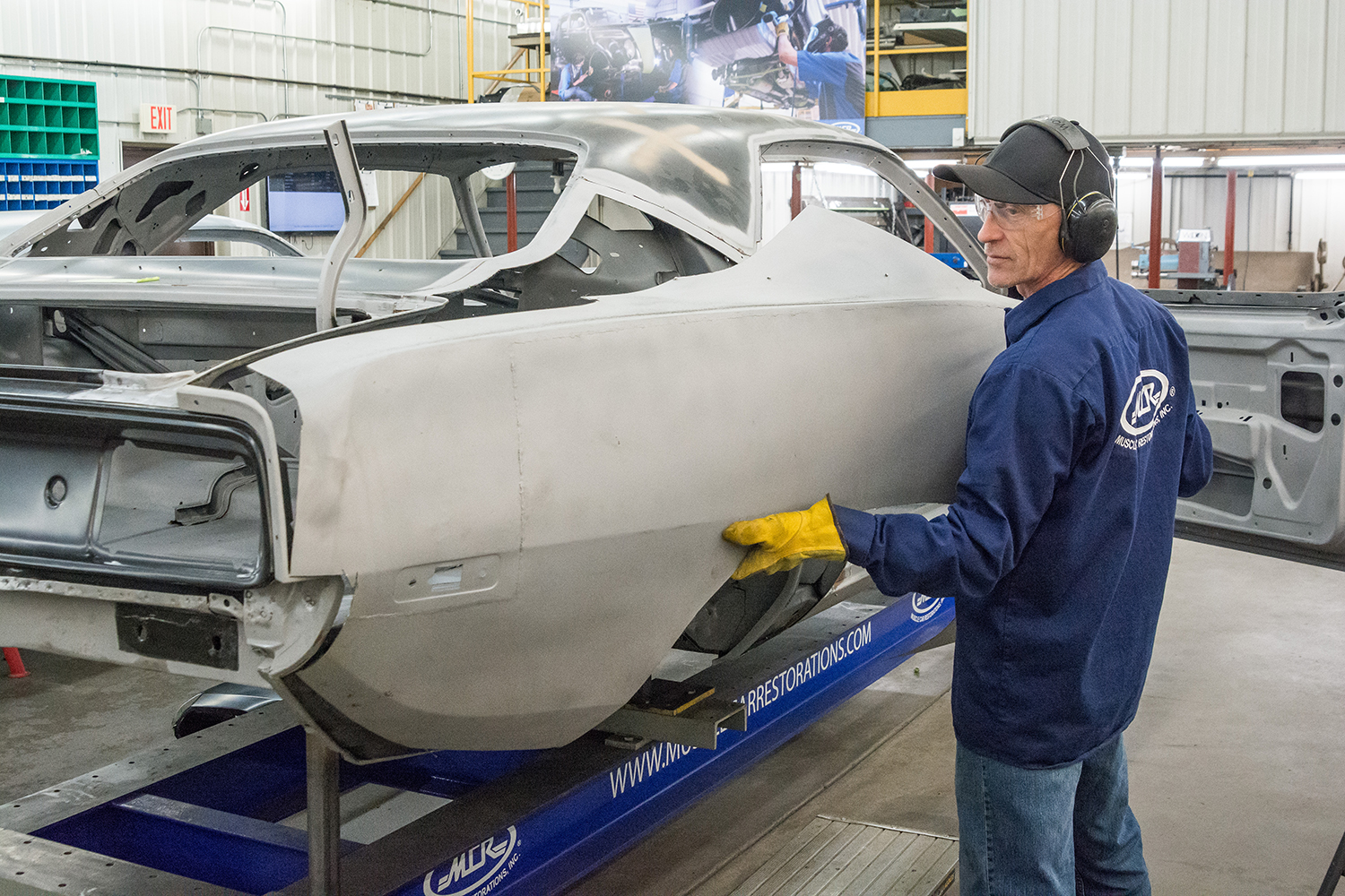 07 worker test fitting the new quarter panel ensuring a proper fit before final installation