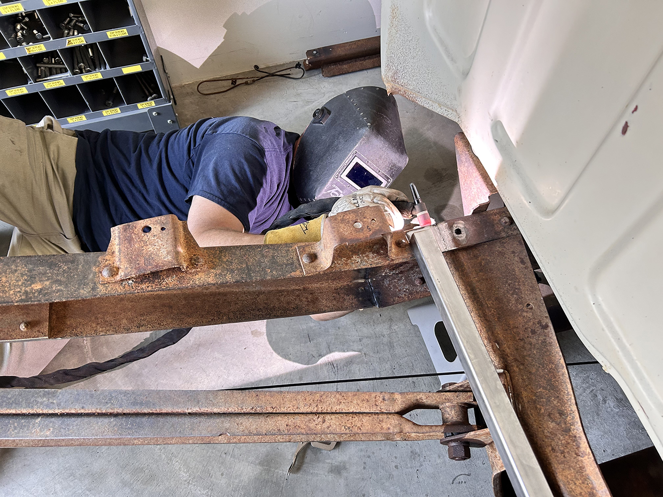 08 Welding work underway beneath the truck's cab for frame reinforcement