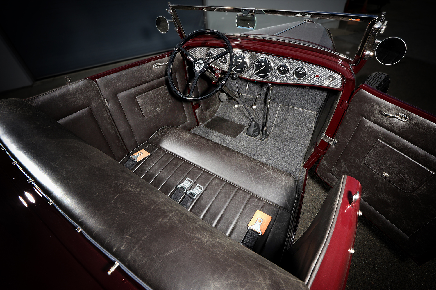 09 1932 Ford Roadster interior with distressed black leather seats a period correct dash and a custom floor shifter