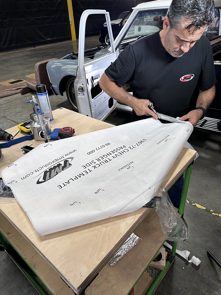 10 Technician cutting TMI door panel template for precise fitment