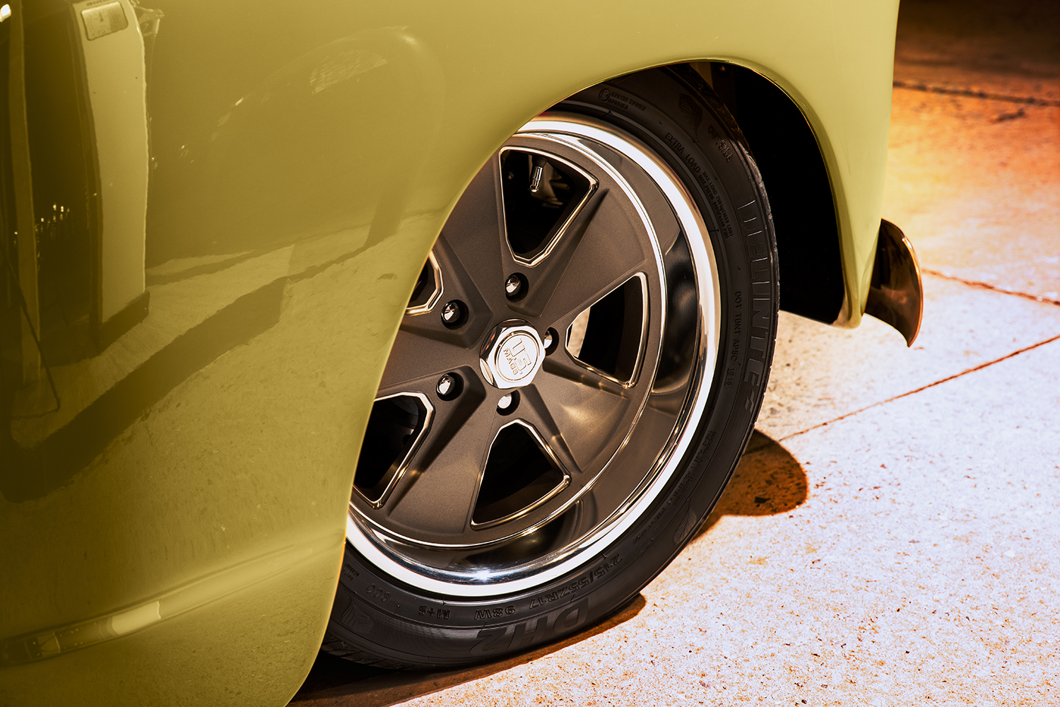 12 1952 Chevrolet 3100 close up of custom bronze multi spoke wheels wrapped in high performance tires