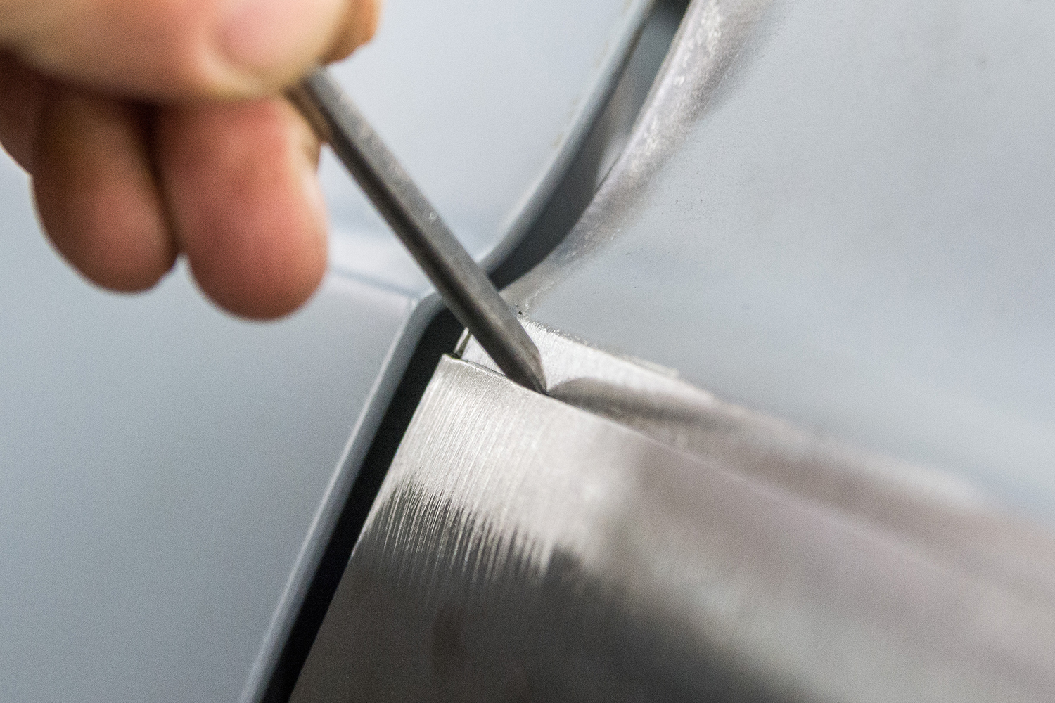 12 close up of a body file being used to ensure perfect alignment of the panel edges