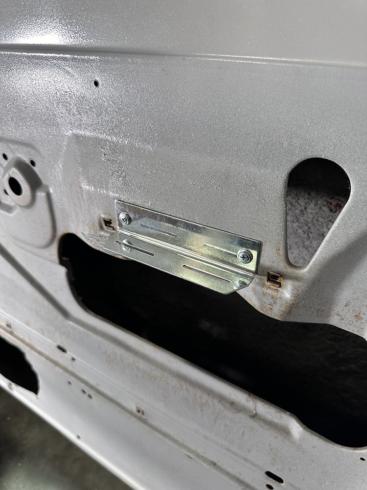13 Metal bracket securely mounted inside door for panel attachment
