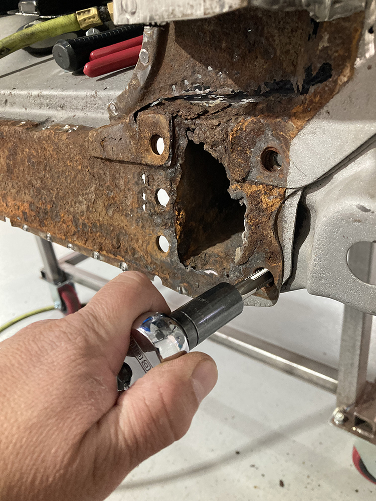 13 Tapping threads into a mounting hole for the new panel installation