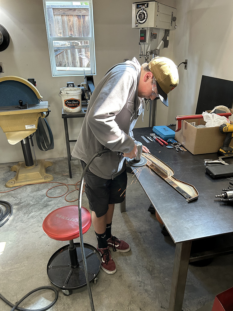 14 Metal shaping and refinishing a trim piece in a workshop setting